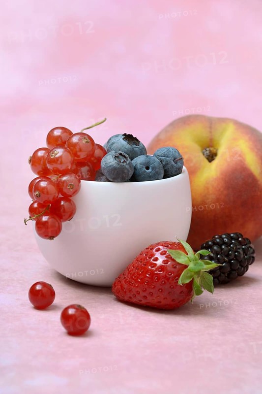 Various fruits in peel, redcurrant, peach, strawberry, blueberry, blackberry