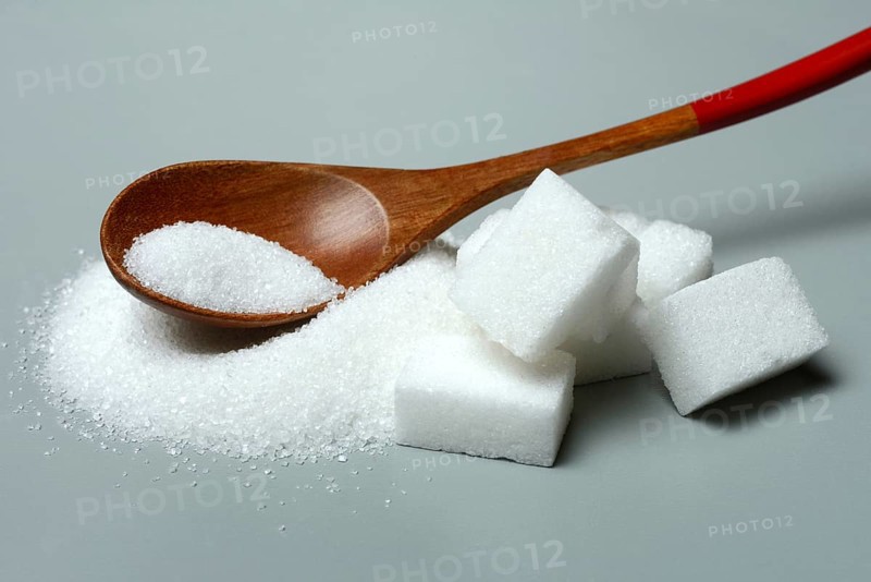Sugar with wooden spoon and sugar cube