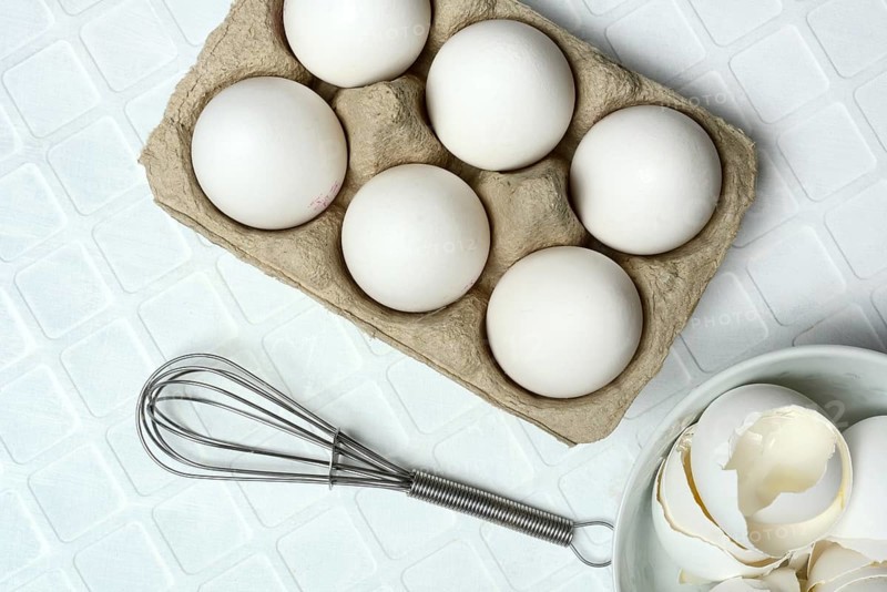 White eggs in packaging with beaters