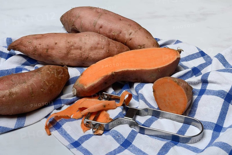 Sweet potatoes with potato peeler, Ipomoea batatas
