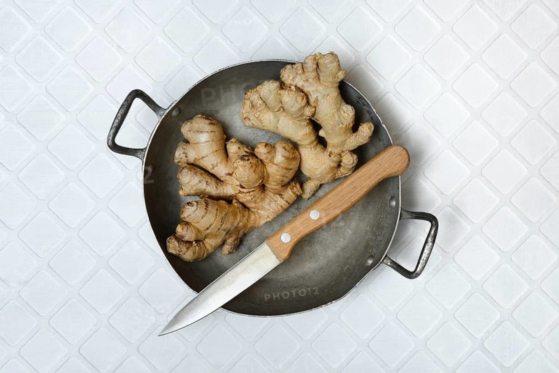 Ginger, ginger tubers in bowl with kitchen knife