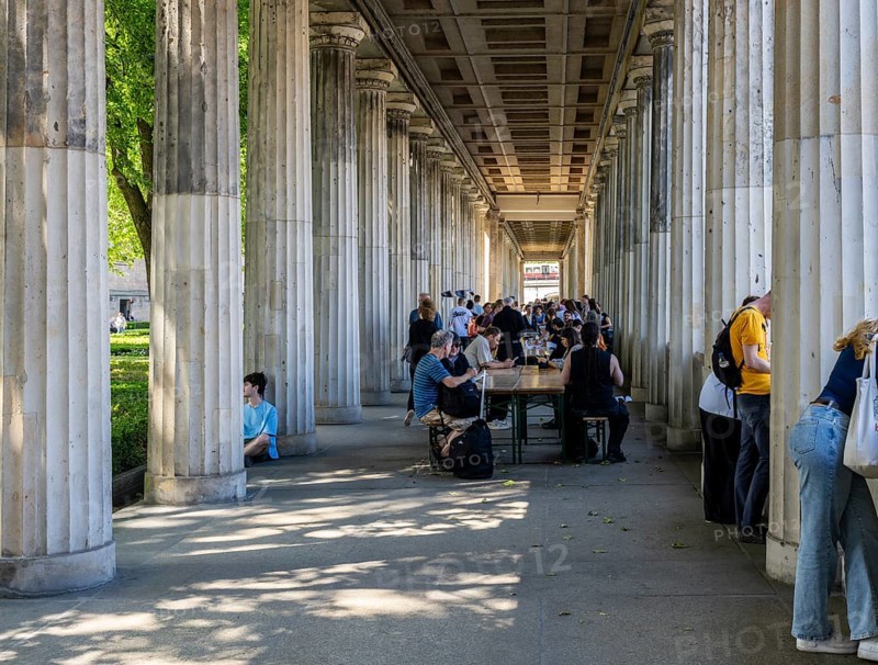 Tourists and passers-by in the colonnade courtyard of the Neues Museum, Bodestraße in Berlin Mitte, Germany