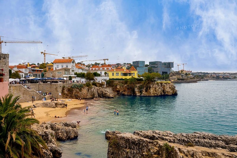View of the old town and a small stretch of beach by the sea, Cascais, Portugal