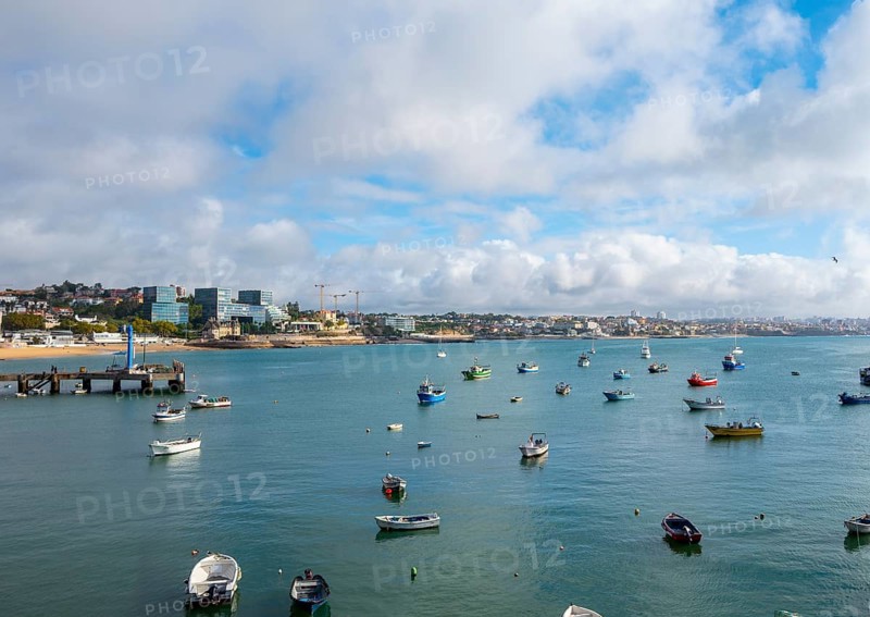 View of fishing boats and a small stretch of beach by the sea, Cascais, Portugal