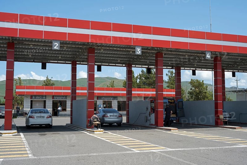 Gas station with red roof, numbered passages and parked cars, gas filling station, Sewan, Gegharkunik province, Armenia
