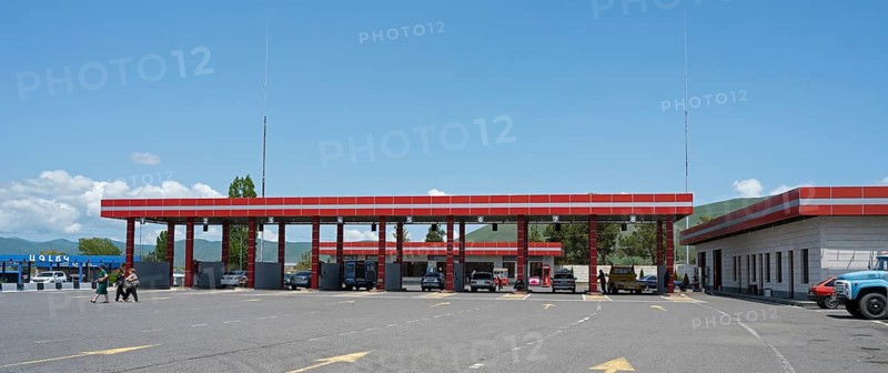 Large red gas station with several cars, pillars and adjacent building, gas filling station, Sewan, Gegharkunik province, Armenia