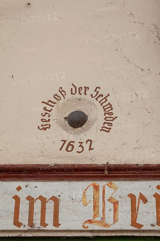 Old cannonball from 1632 in the wall of the bridge house on the Nahe bridge in Bad Kreuznach, Germany. Bullet of the Swedes