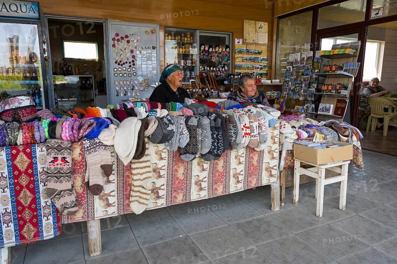 Two woman selling colorful hand-knitted clothes at a market stall, Noratus, Noradus, Gegharkunik province, Armenia