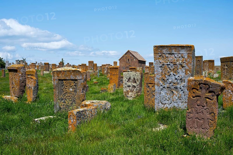 Ancient tombstones with carved patterns on an extensive green meadow, cross stones, khachkars, world's largest khachkar field, Noratus cemetery, Noradus, Gegharkunik province, Armenia