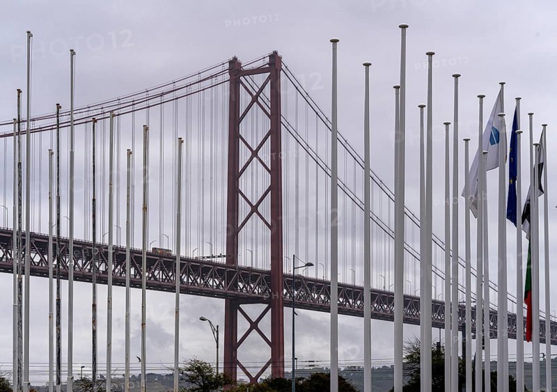 The Ponte 25 de Abril, 3.2 km long bridge in Portugal with a 2278 meter long suspension bridge across the Tagus, cloudy and rainy weather, third-longest suspension bridge with combined road and rail traffic, Lisbon, Portugal
