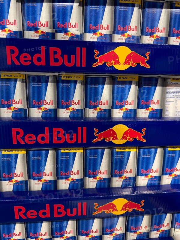Red Bull soft drink in stacked aluminum cans aluminum cans at retail grocer, Germany
