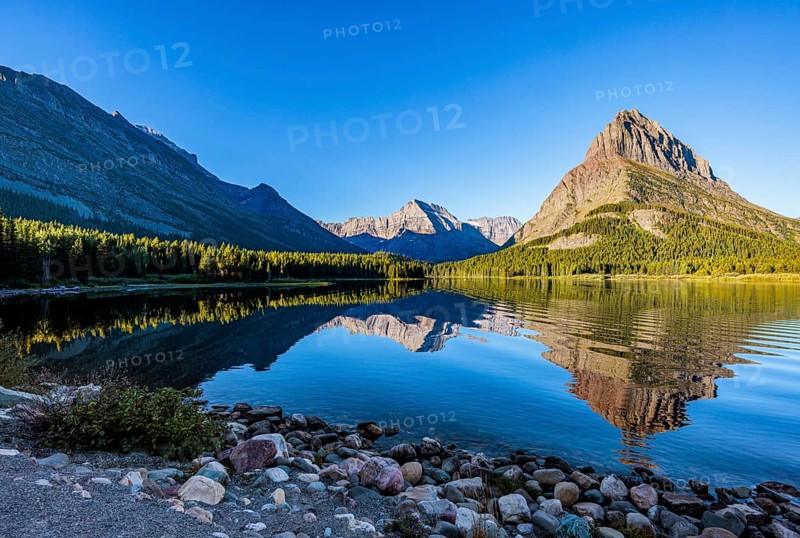 240831_066 Rippled reflection of the mountains on the calm waters of Lake Josephine in Glacier National Park, Montana, USA