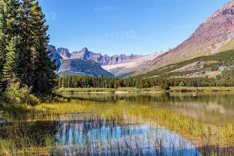 240831_325 Rugged Mountains rise up behind Swiftcurrent lake in Glacier National Park, Montana, USA