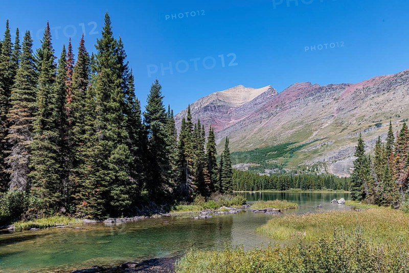 240831_301 Rugged Mountains rise up behind the south end of Swiftcurrent lake in Glacier National Park, Montana, USA
