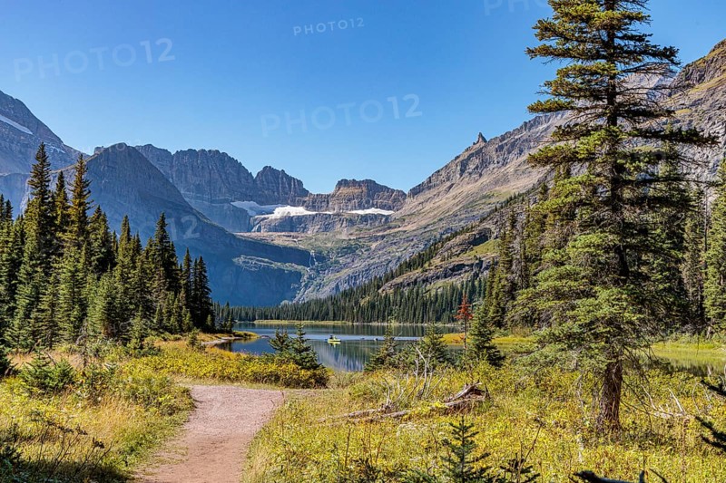 240831_277 Couple canoing on Josephine Lake surrounded by the rugged mountains of Glacier National Park, Montana, USA