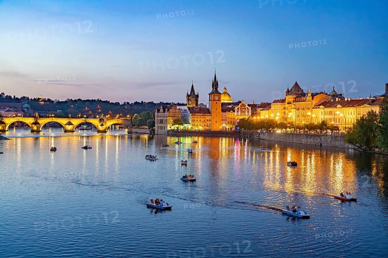 Vltava embankment with Old Town Water Tower, Novotný Bridge and Charles Bridge at dusk, Prague, Czech Republic