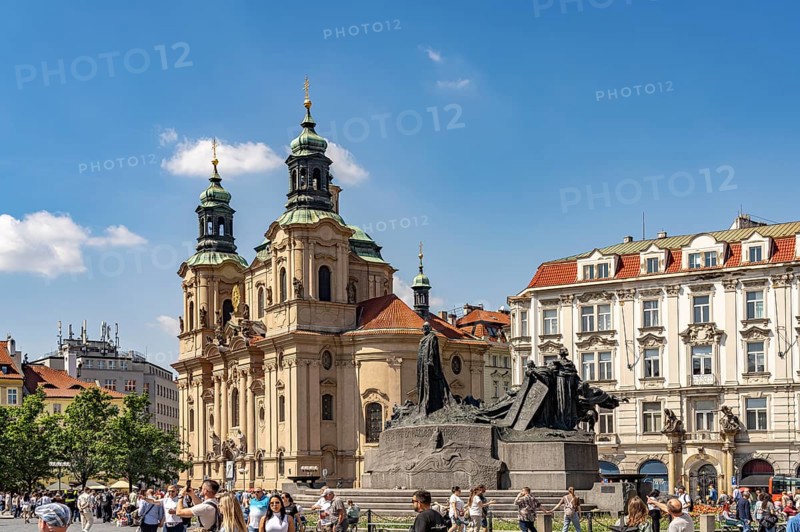 The Baroque St. Nicholas Church and the Jan Hus Memorial on Old Town Square in Prague, Czech Republic