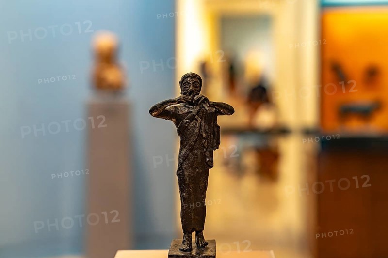 Bronze miniature of a flute player in the Archaeological Museum of Delphi, UNESCO World Heritage Site in Delphi, Greece