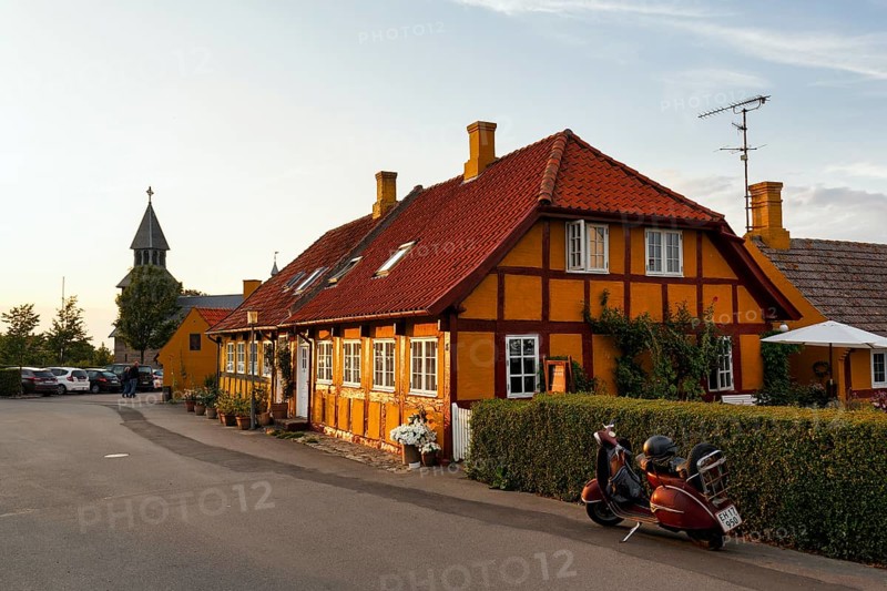 Characteristic half-timbered houses, street scene with church tower, Gudhjem, Bornholm, Baltic Sea, Denmark