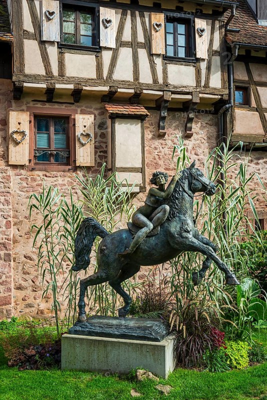 Statue of a woman riding with horse La Dame du Parc in Riquewihr