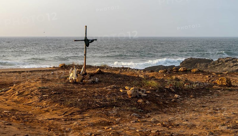 Religious scene, temporary Christian cross on the coast Farol de Cabo Raso lighthouse, São Bras de Sanxete fortress, Cascais, Portugal