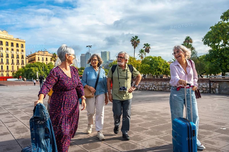 Group of senior friends happily walking together through a city exploring new destinations, enjoying their vacation and an active retirement lifestyle