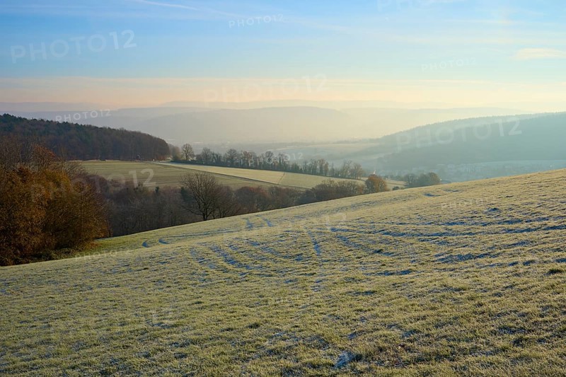 Morning fog hovers over a green, hilly landscape under clear skies, Seckmauern, Lützelbach, Maintal, Odenwald, Hesse, Germany
