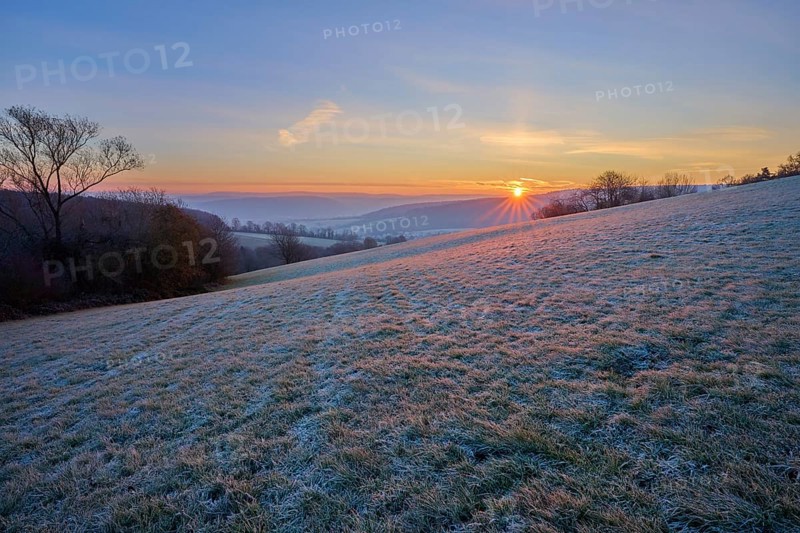 A frosty morning with sunrise over a rolling landscape, Seckmauern, Lützelbach, Maintal, Odenwald, Hesse, Germany