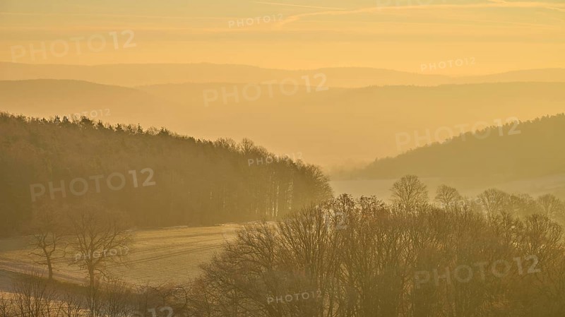 Blurred hills and golden sky at sunrise create a misty, quiet landscape, Seckmauern, Lützelbach, Maintal, Odenwald, Hesse, Germany