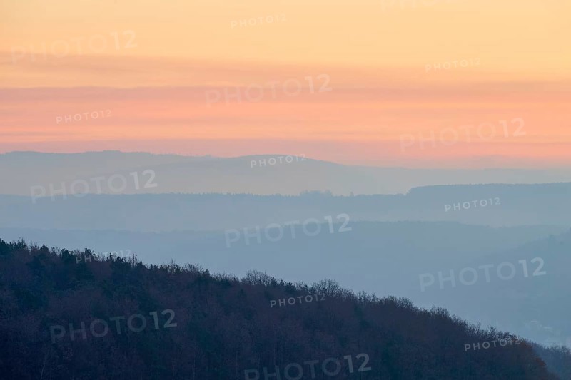 Pastel-colored silhouettes of hills and trees at sunset convey a peaceful atmosphere, Seckmauern, Lützelbach, Maintal, Odenwald, Hesse, Germany
