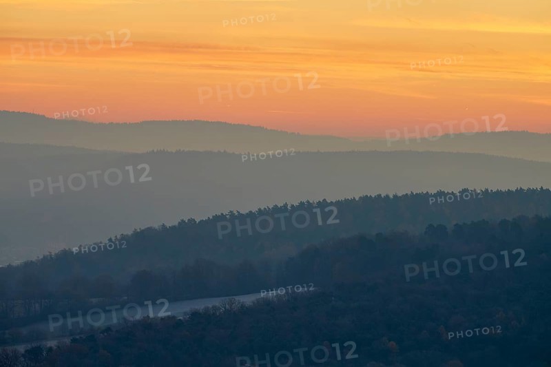 Gentle hills in fog at a warm sunset create a peaceful natural landscape, Seckmauern, Lützelbach, Maintal, Odenwald, Hesse, Germany