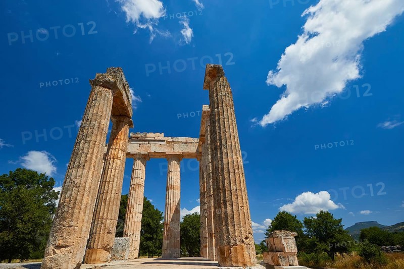 Pillars of an ancient structure under a clear sky with few clouds, Nemea, Ancient Zeus Heightum, Archaeological Site, Peloponnese, Greece