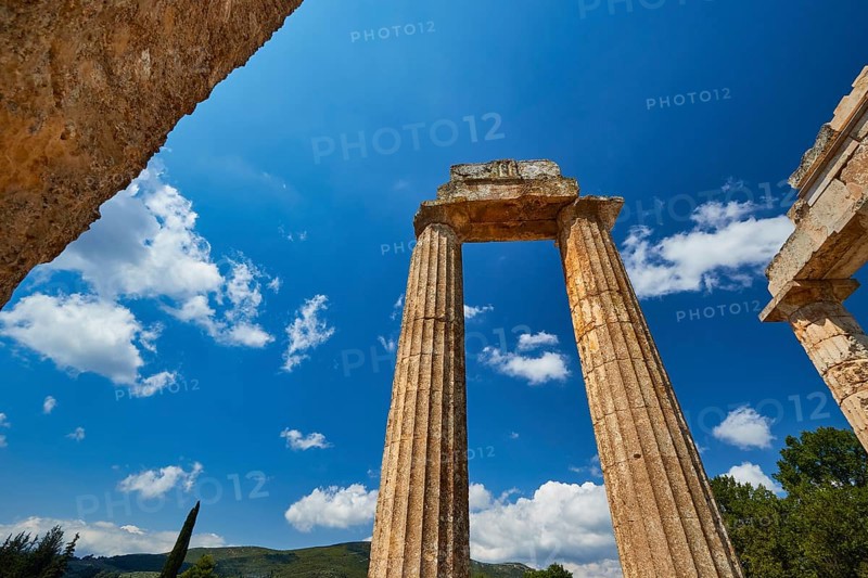 Massive ancient pillars rise against a bright blue sky, Nemea, Ancient Zeus Church, Archaeological Site, Peloponnese, Greece