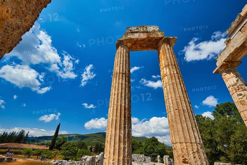 Ancient ruins stand imposing against a clear blue sky with some clouds, Nemea, Ancient Zeus Church, Archaeological Site, Peloponnese, Greece