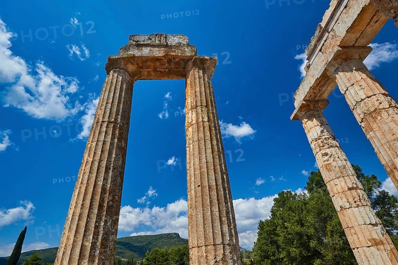 Single ancient column and ruins with clear sky, Nemea, Ancient Zeus Heightum, Archaeological Site, Peloponnese, Greece