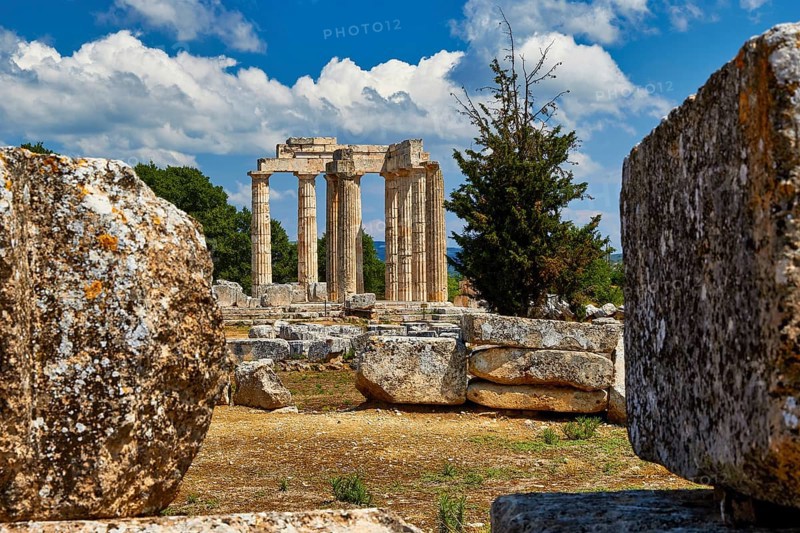 Ancient Greek ruins with columns under a blue sky with clouds, Nemea, Ancient Zeus Heightum, Archaeological Site, Peloponnese, Greece