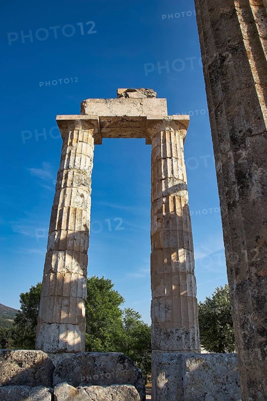 Single antique column with clear sky in the background. Greek Ruins, Nemea, Ancient Zeus Heightum, Archaeological Site, Peloponnese, Greece