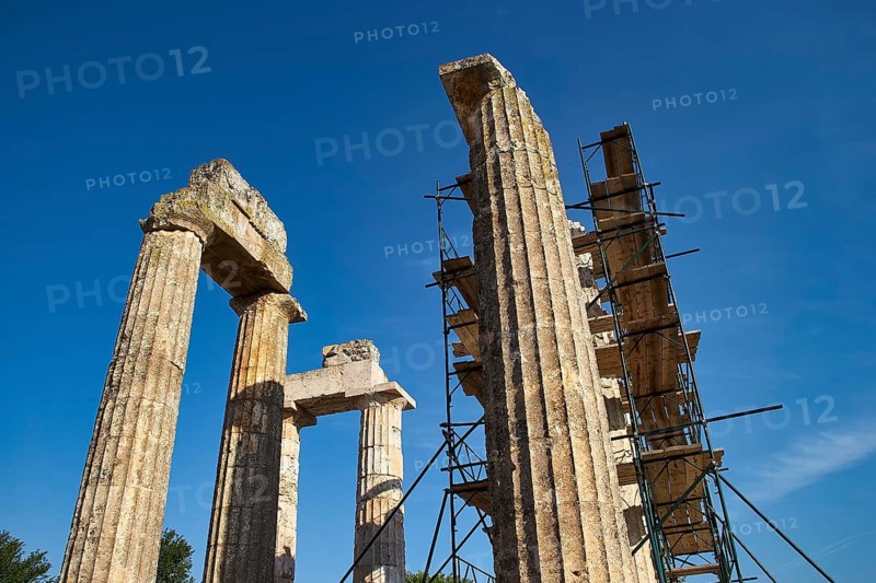 Old pillars with scaffolding, clear sky. Greek Ruins, Nemea, Ancient Zeus Heightum, Archaeological Site, Peloponnese, Greece