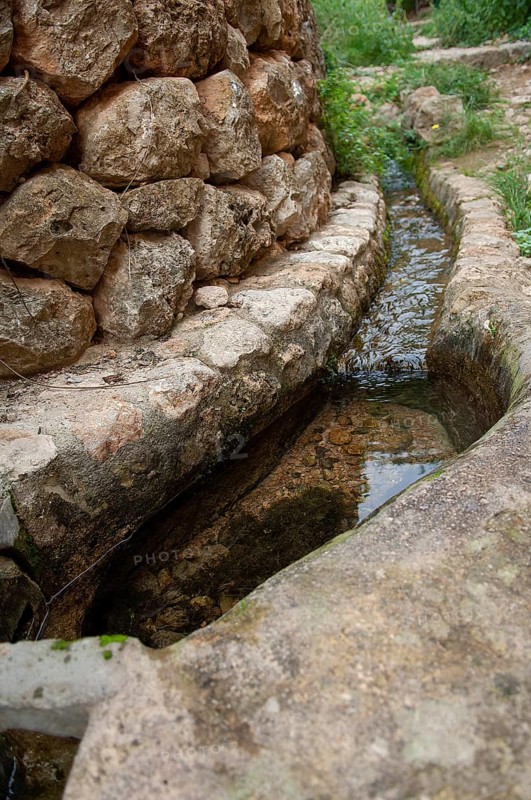 Small trickle on a laying stone wall, Majorca, Spain
