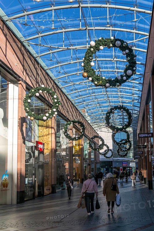 Christmas shoppers inside covered shopping street, Princesshay shopping centre, Exeter, Devon, England, UK