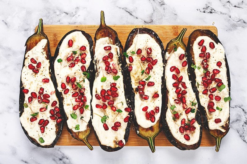 Fried eggplant with sauce, decorated with microgreens and pomegranate seeds, eggplant appetizer, top view, homemade, no people