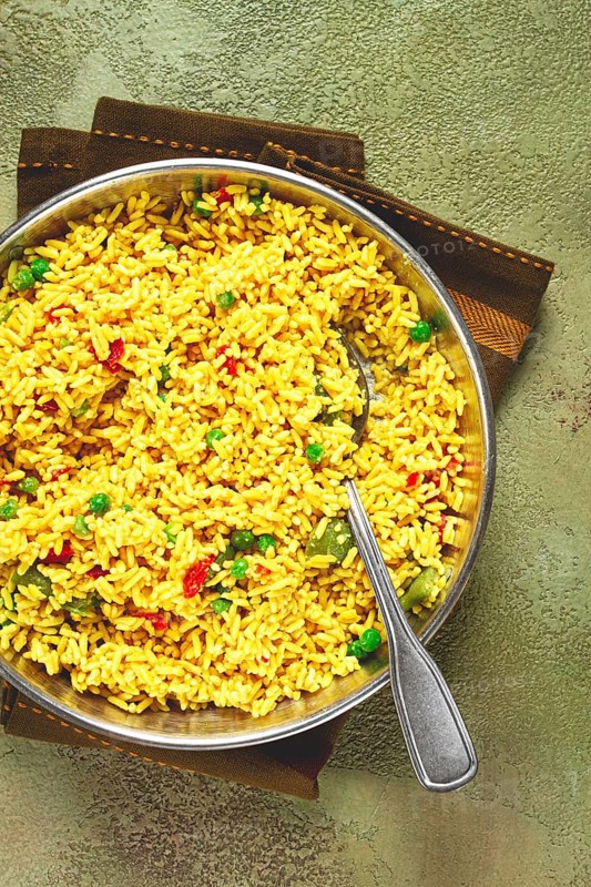 Rice with saffron and vegetables, in a frying pan, top view, homemade, no people