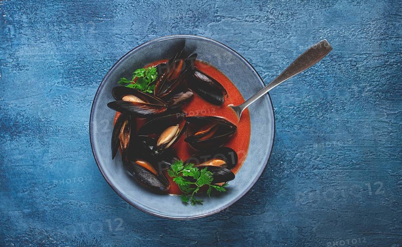 Fra Diavolo mussels, mussels in tomato sauce, Italian dish, on a blue background, homemade, no people