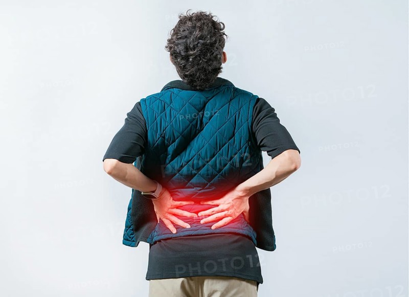 Person with spine problems. Man with pain holding his back. Lumbar problems. Suffering male with pain holding his back isolated