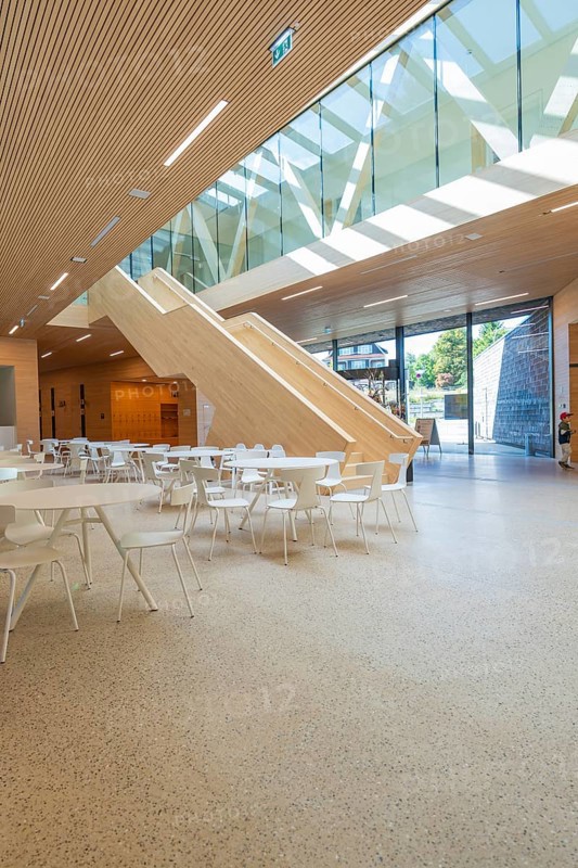 Spacious, modern atrium with wooden paneling and glass roof, furnished with white minimalist furniture, Ruhestein National Park Center, Black Forest, Baiersbronn, Germany