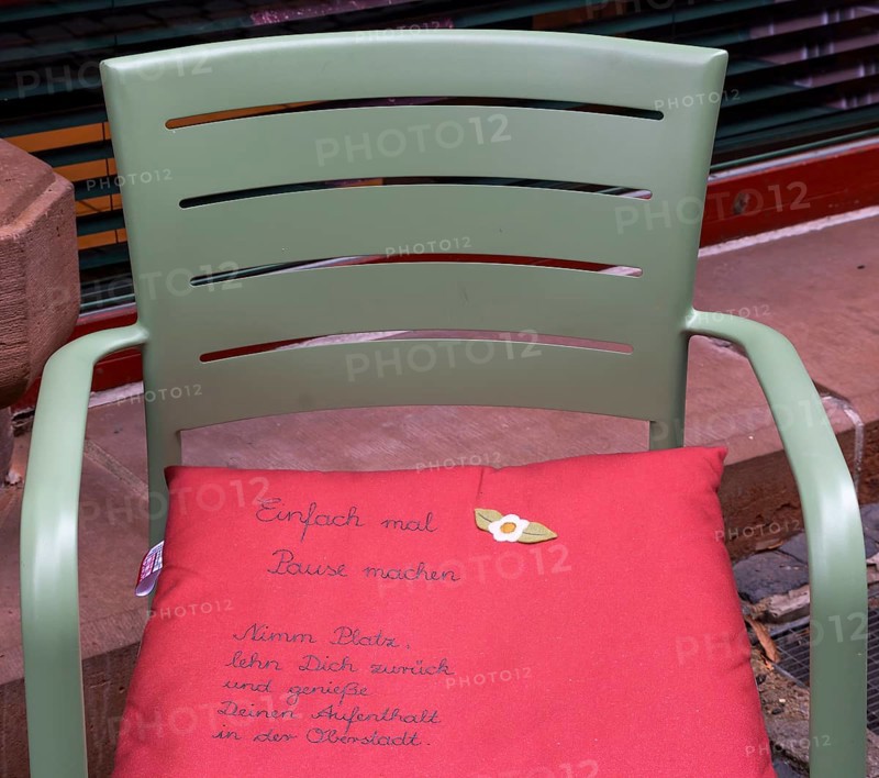 Cushion on chair with city advertising, Oberstadt, Marburg, Hesse, Germany