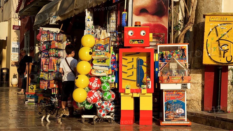 Old town of Nauplion, A colorful toy store with a retro robot and balloons in a sunny street, Nauplion, Nafplion, Peloponnese, Greece