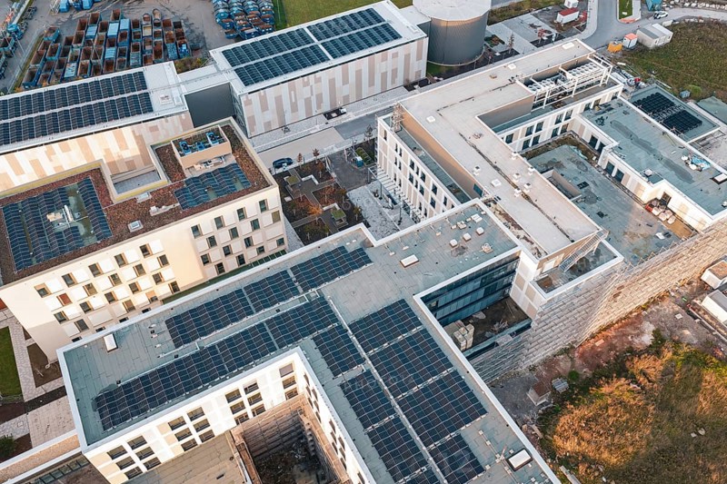 Aerial view of building roofs with solar systems and surrounding roads, new hospital, Calw Health Campus, Black Forest, Germany