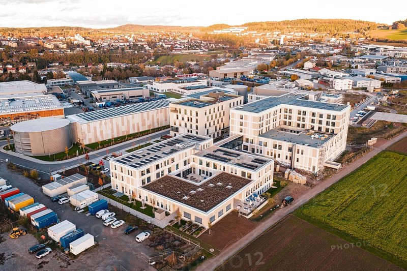 Aerial view of a city panorama with modern buildings and adjacent fields, new hospital, Calw health campus, Black Forest, Germany