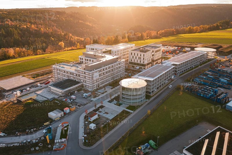 Aerial view of a modern building complex in rural area at sunset, new hospital, Calw Health Campus, Black Forest, Germany